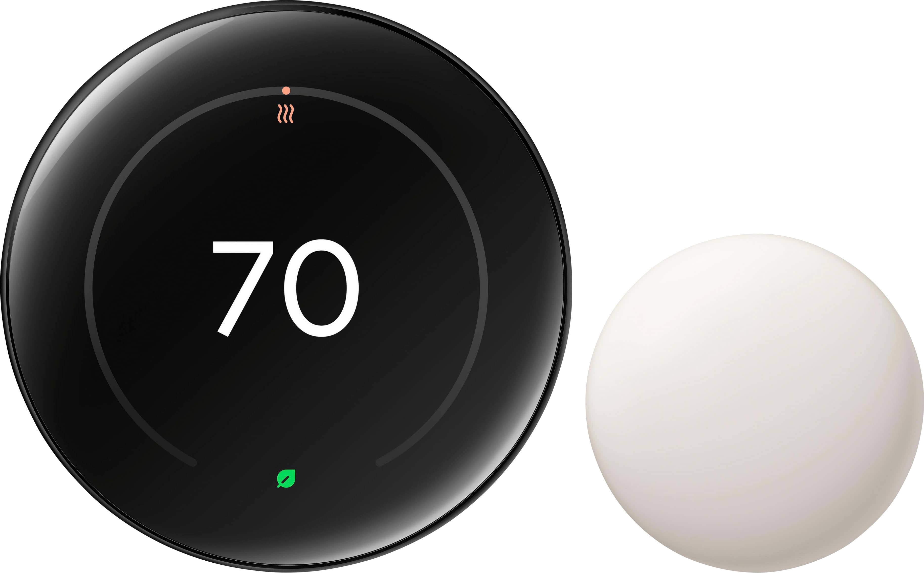 Google Nest Learning Thermostat installed on a wall showing the polished obsidian finish and temperature sensor placement